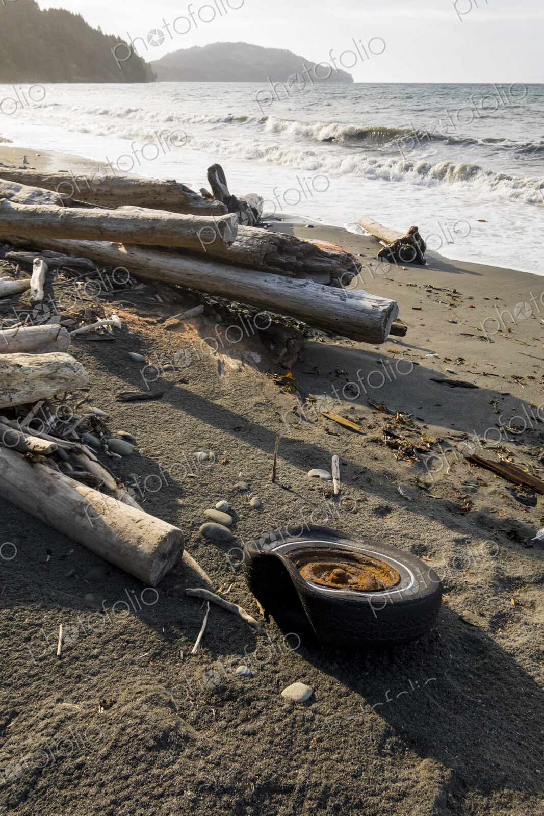 Old tire on wilderness beach, Freshwater Bay, Port Angeles.