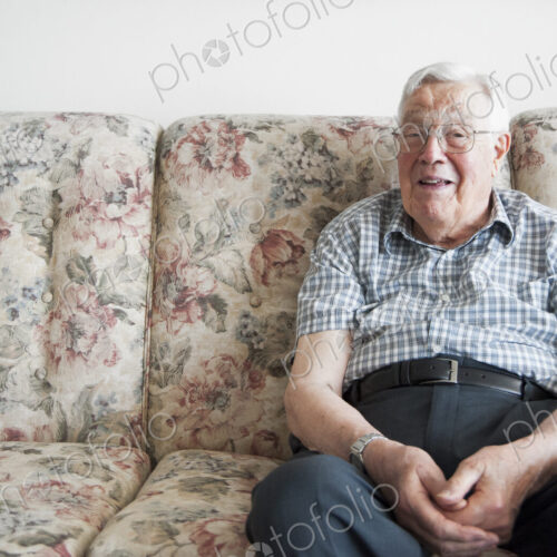 Older man sitting on sofa
