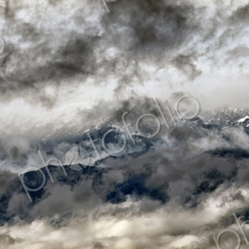 Olympic mountains seen through heavy cloud layer. Olympic mountains seen through heavy cloud layer.