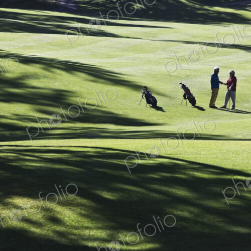 One golfer shking hands with another after making a great golf shot. One golfer shking hands with another after making a great golf shot.