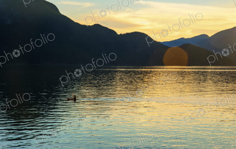One person kayaking at sunset in Howe Sound near Porteau Cove.