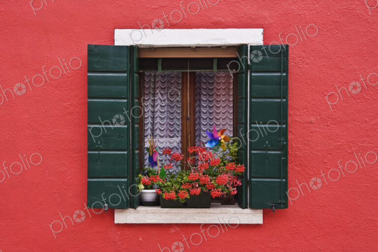 Open Shuttered Window in Red Wall