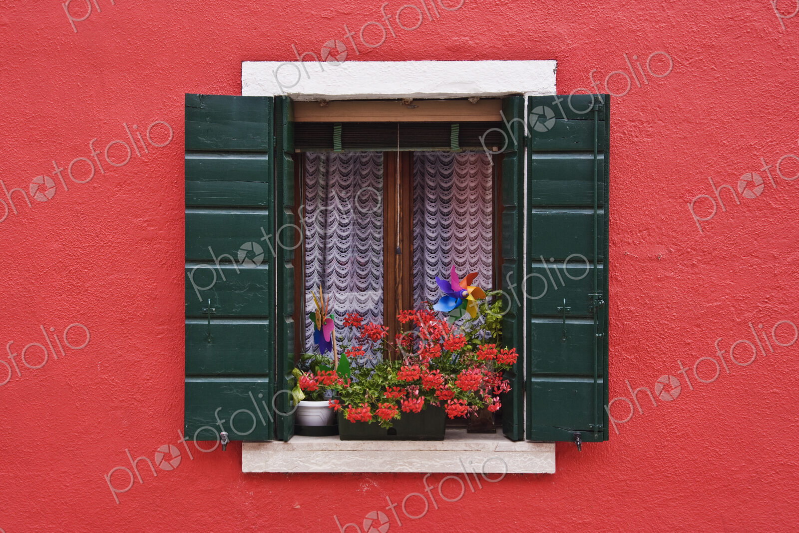 Open Shuttered Window in Red Wall