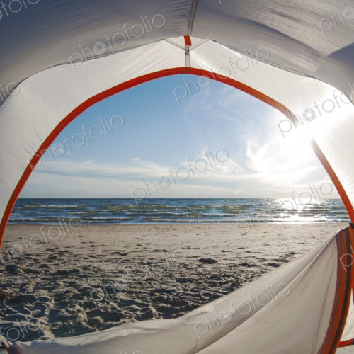Open camping tent door on beach Open camping tent door on beach