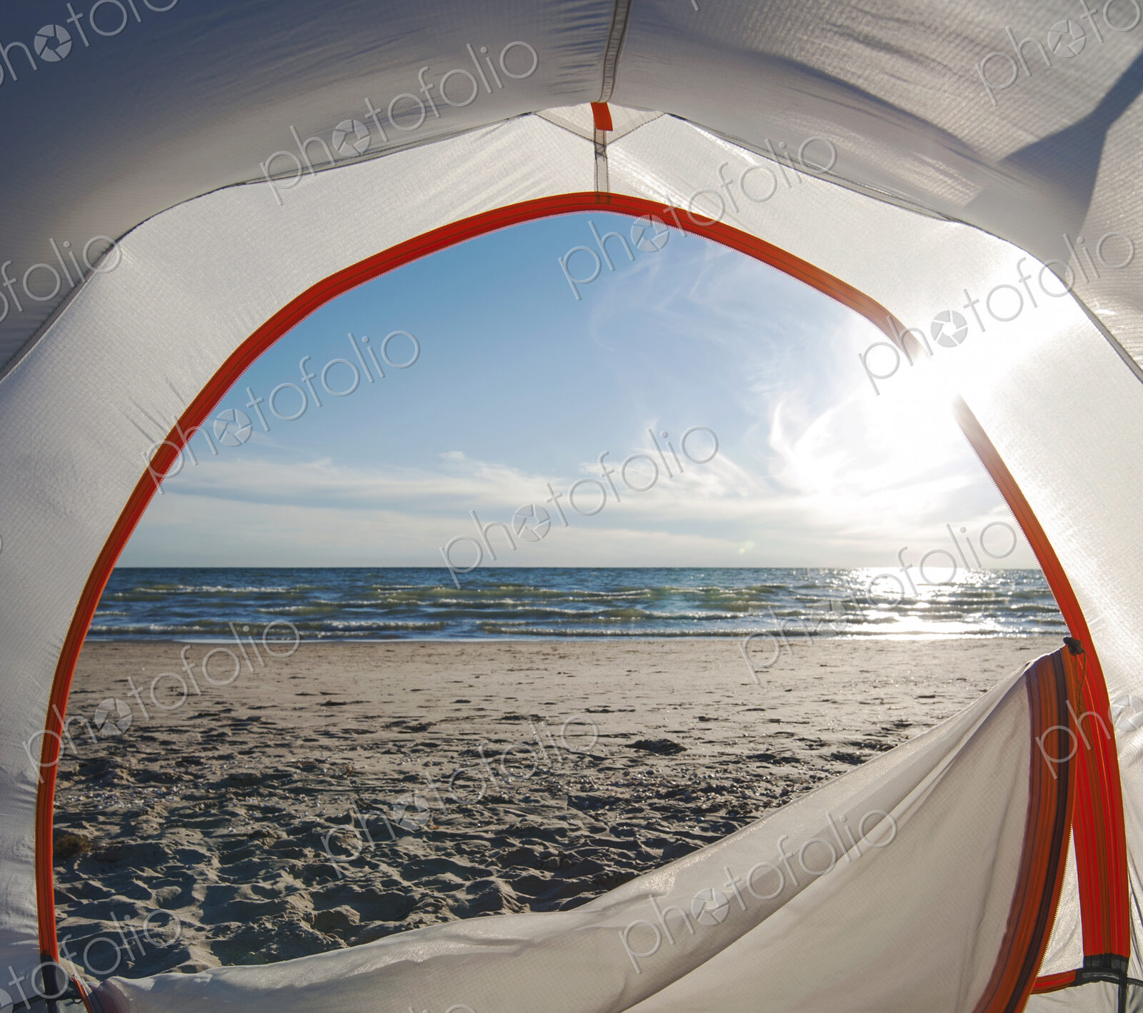 Open camping tent door on beach