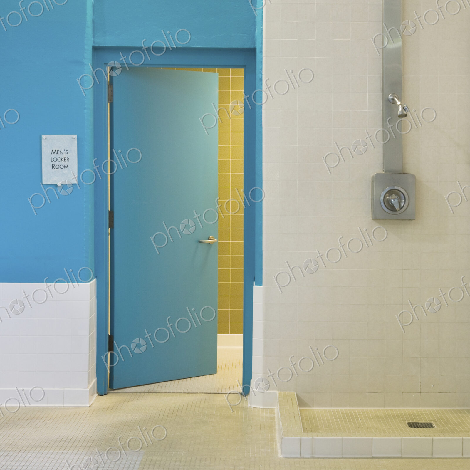 Open door and shower in locker room.