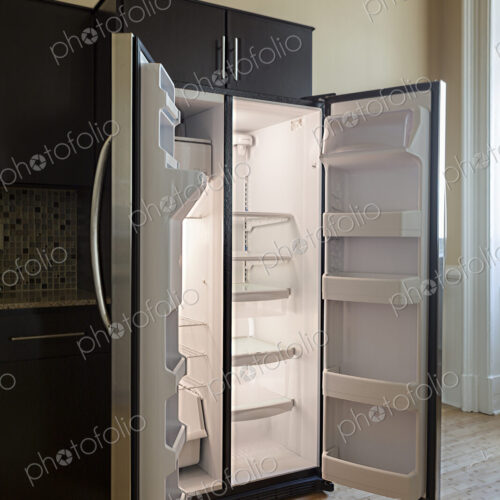 Open empty refrigerator in modern kitchen Open empty refrigerator in modern kitchen
