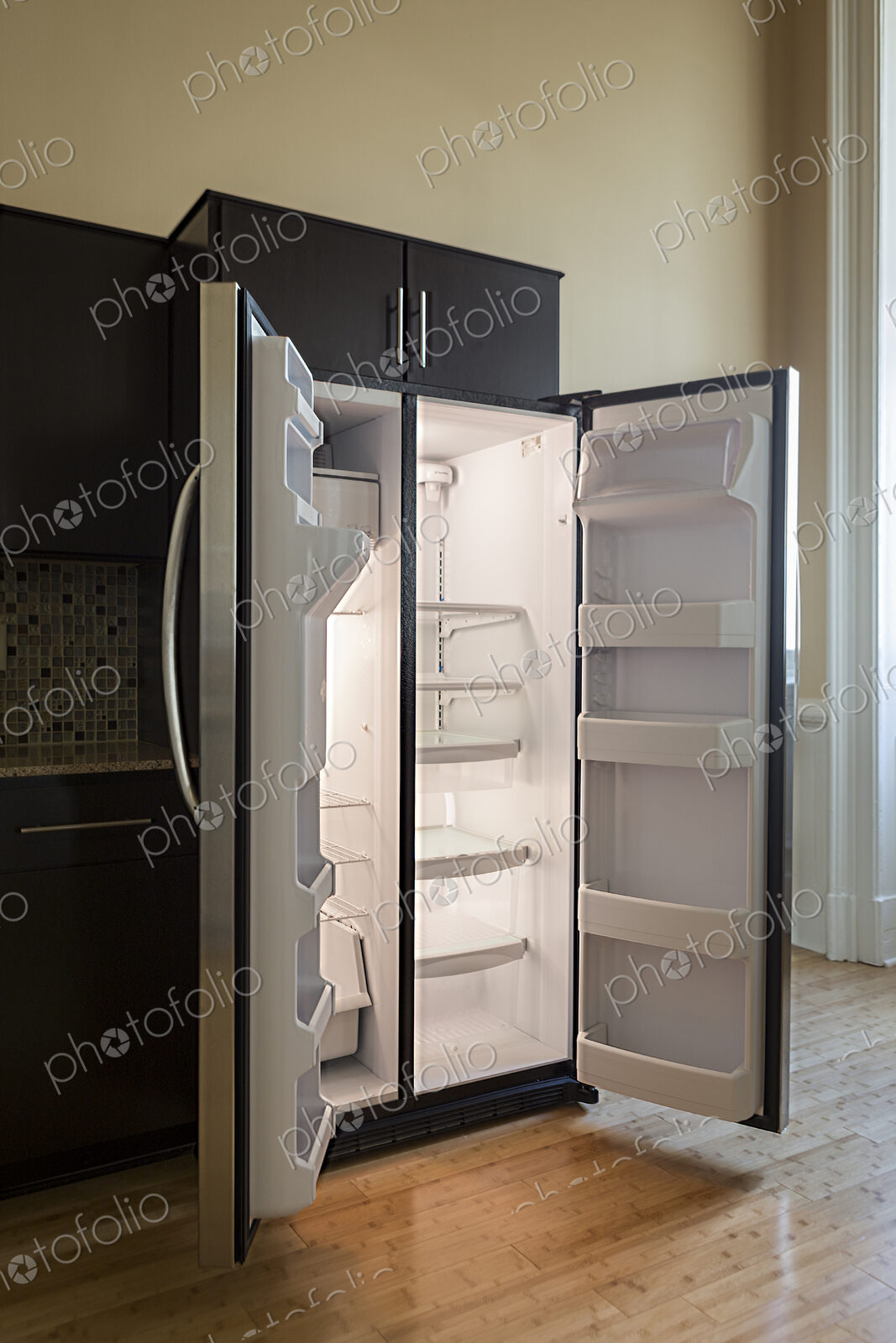 Open empty refrigerator in modern kitchen