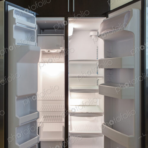 Open empty refrigerator in modern kitchen Open empty refrigerator in modern kitchen