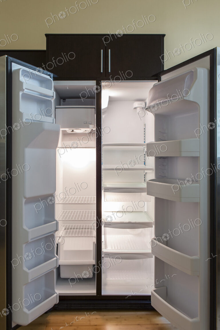Open empty refrigerator in modern kitchen
