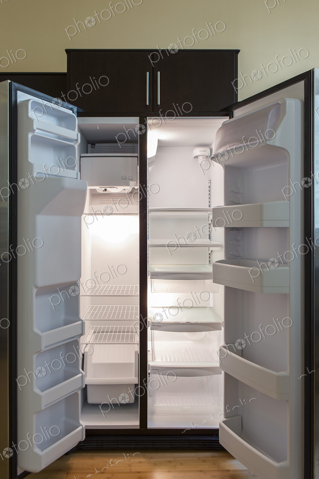 Open empty refrigerator in modern kitchen