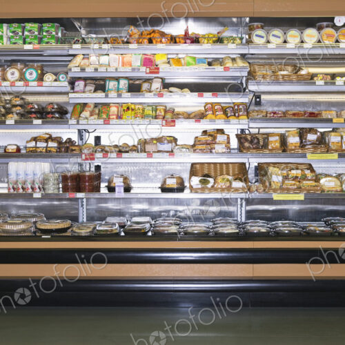 Open refridgerator stocked with food in supermarket. Open refridgerator stocked with food in supermarket.