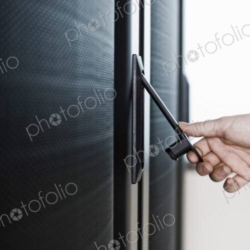 Opening the door to a rack holding servers in a computer server farm. Opening the door to a rack holding servers in a computer server farm.