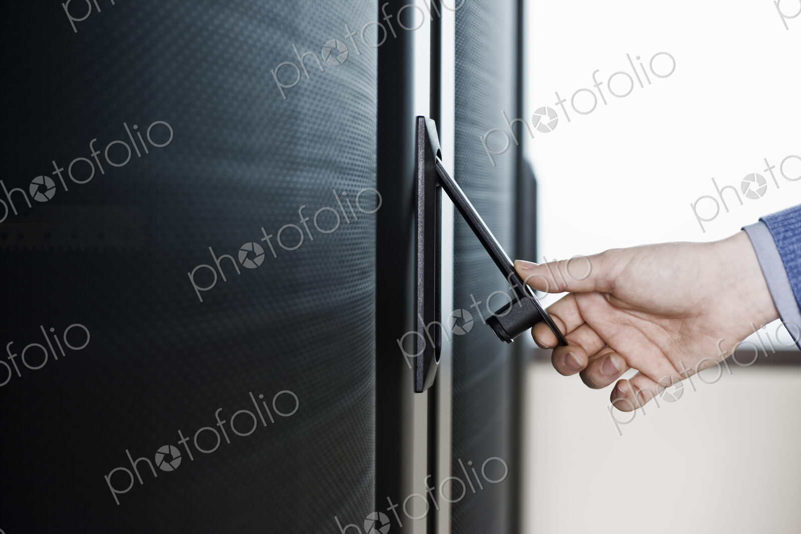 Opening the door to a rack holding servers in a computer server farm.