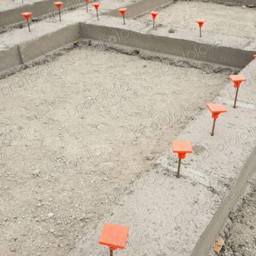 Orange Caps in Cement Foundation