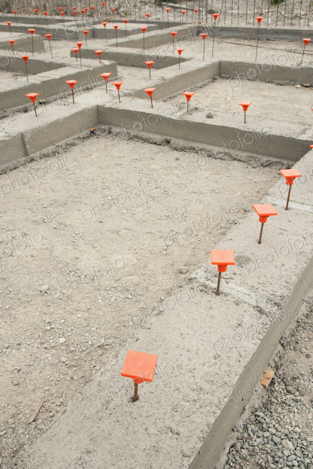Orange Caps in Cement Foundation
