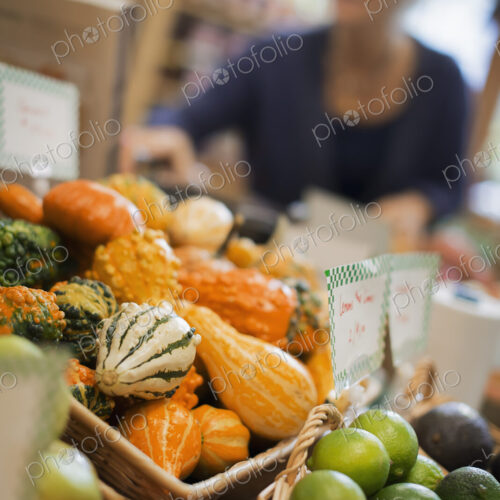 Organic Farmer at Work. A farm stand, with a display of goudes and squash of different… Organic Farmer at Work. A farm stand, with a display of goudes and squash of different…
