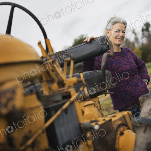 Organic Farmer at Work. A woman by a tractor. Organic Farmer at Work. A woman by a tractor.