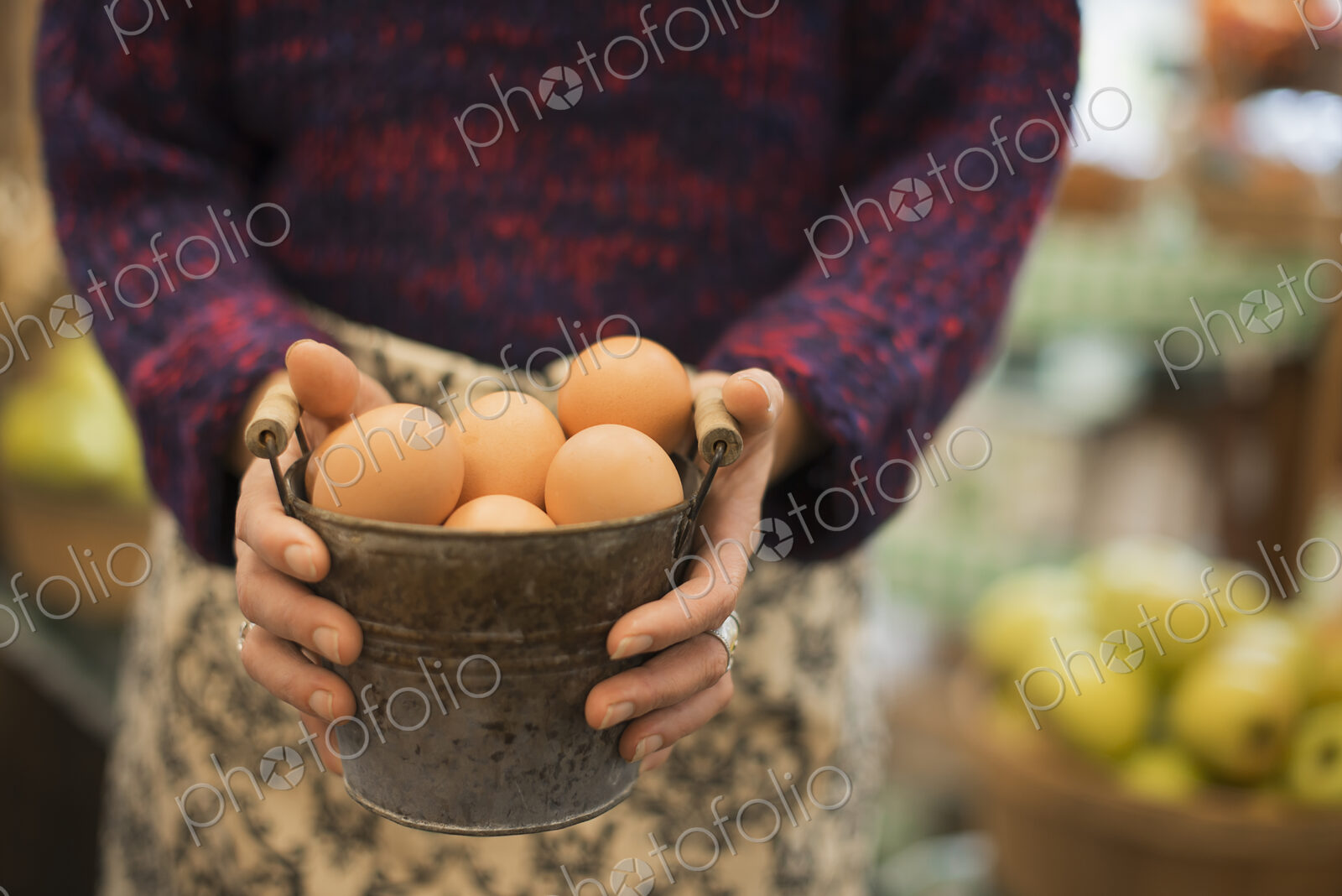 Organic Farmer at Work. A woman carrying a container of eggs.