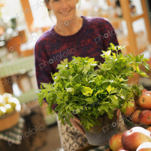 Organic Farmer at Work. A woman working ona farm stand, witha display of fresh… Organic Farmer at Work. A woman working ona farm stand, witha display of fresh…