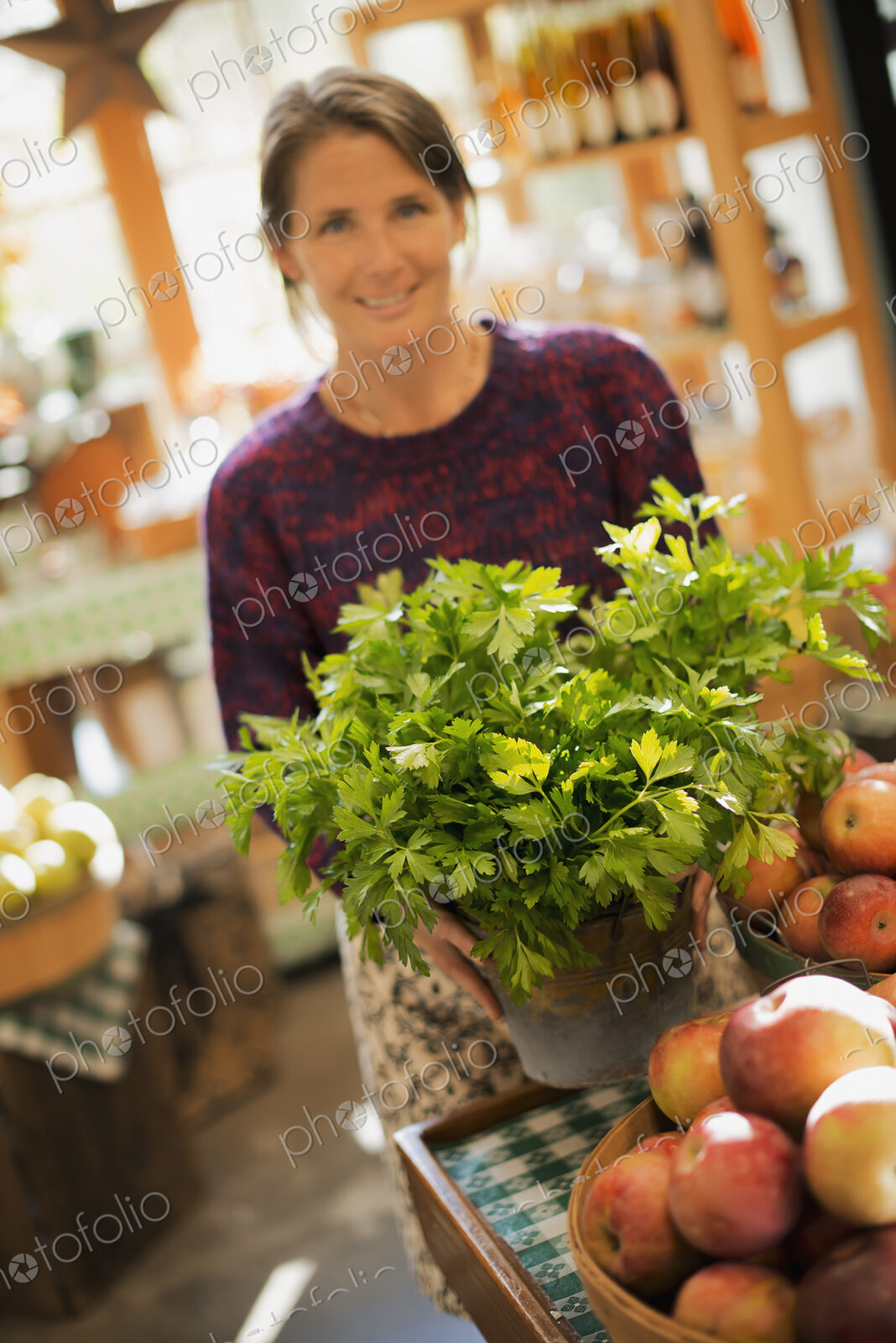 Organic Farmer at Work. A woman working ona farm stand, witha display of fresh…