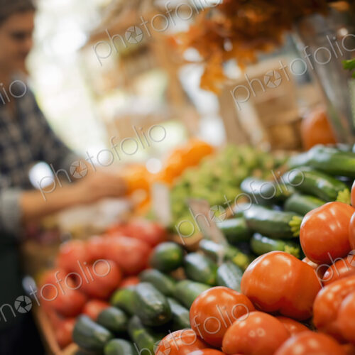 Organic Farmer at Work. A young man arranging a display of fresh produce on a farm…