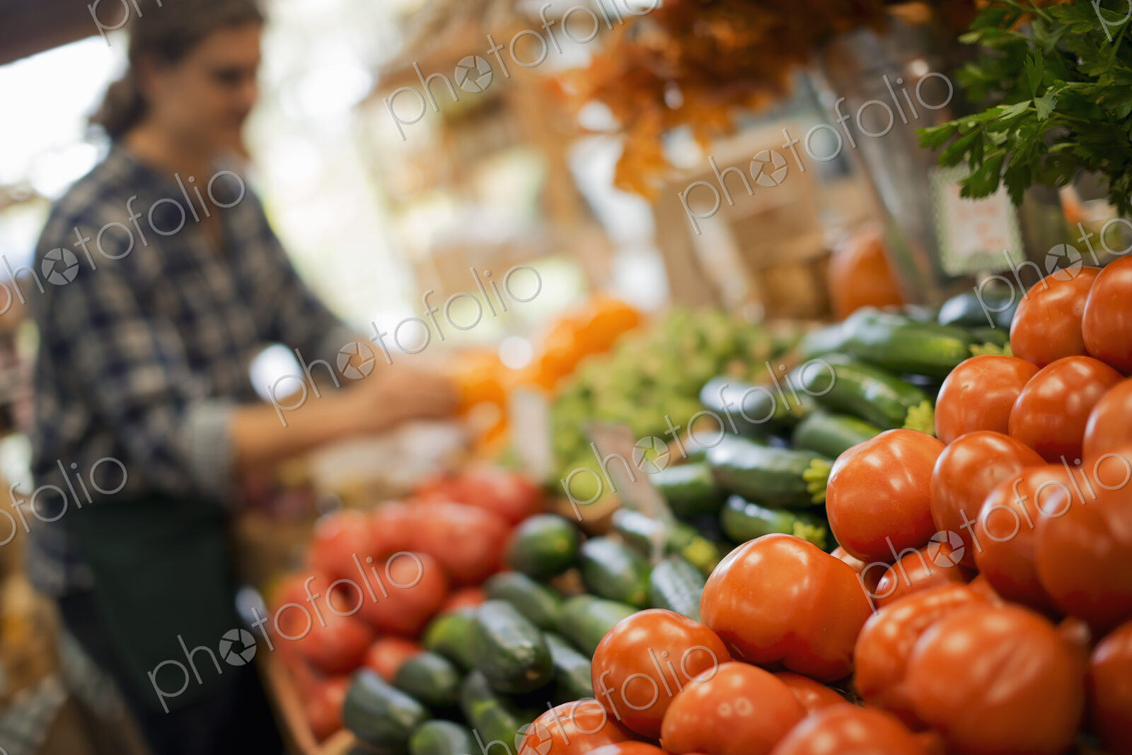 Organic Farmer at Work. A young man arranging a display of fresh produce on a farm…