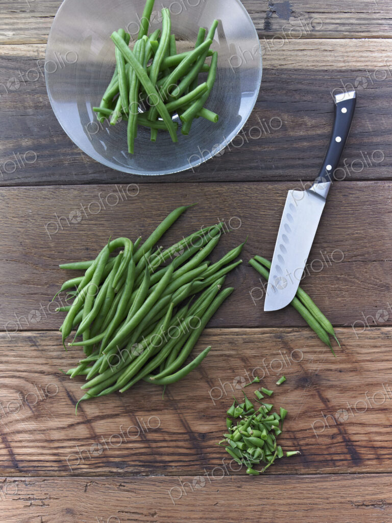 Organic Green Beans Being Prepared for Cooking on Reclaimed Lumber Counter Top