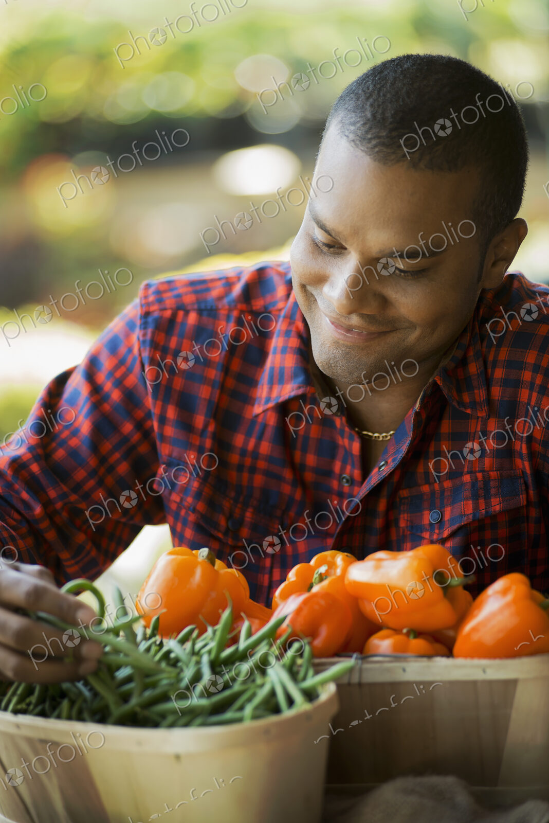 Organic Vegetable on Display with Farmer; Green Beans; Yellow and Red Bell Peppers
