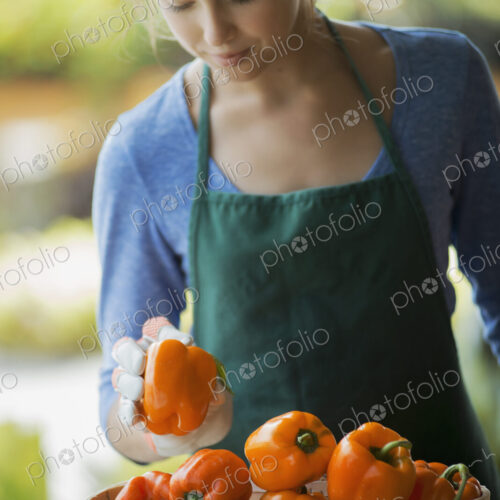 Organic Vegetable on Display with Farmer; Organic Yellow and Red Bell Peppers