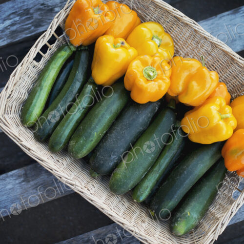 Organic Zucchini in basket with Yellow and Orange Bell Peppers