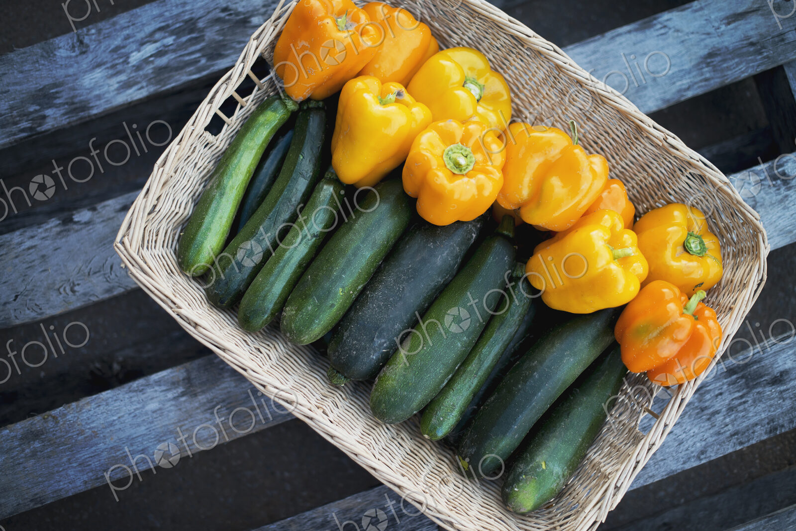 Organic Zucchini in basket with Yellow and Orange Bell Peppers