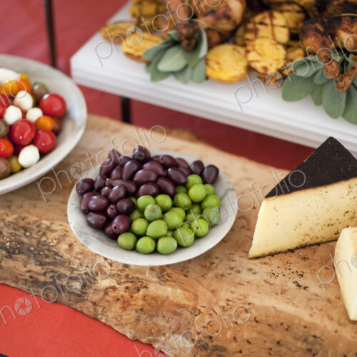 Organic food presented on white dishes for a party. Cheese, free range chicken,…