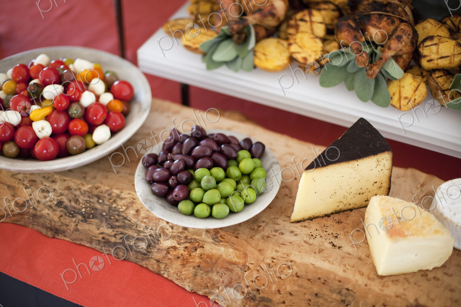 Organic food presented on white dishes for a party. Cheese, free range chicken,…