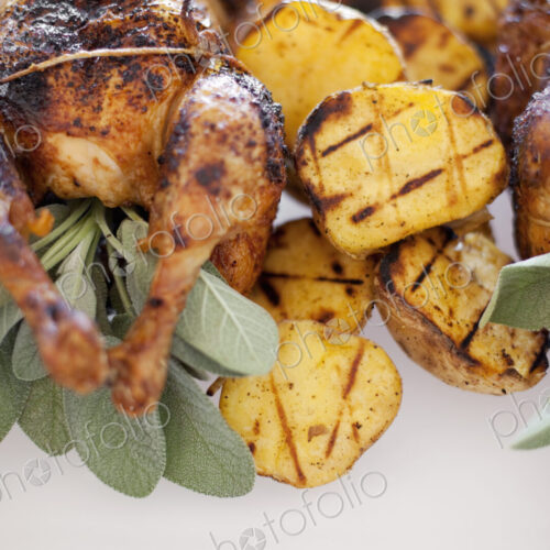 Organic free-range cooked chicken and roasted potatoes on a dish. Food for a party.