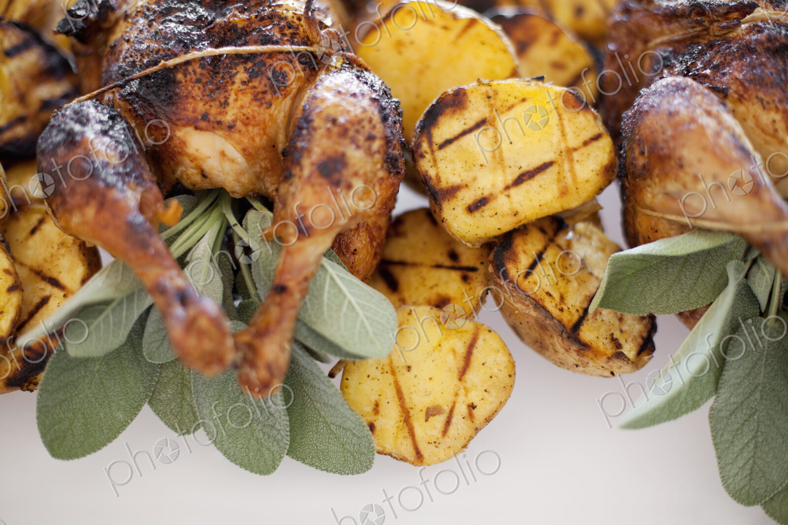 Organic free-range cooked chicken and roasted potatoes on a dish. Food for a party.