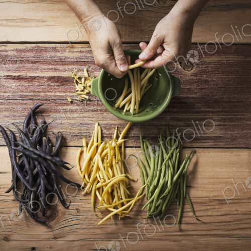 Organic green, yellow and black haricot beans, fresh vegetables being topped and… Organic green, yellow and black haricot beans, fresh vegetables being topped and…