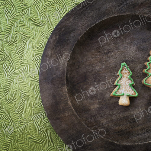 Organic homemade Christmas cookies in the shape of Christmas trees on a round wooden… Organic homemade Christmas cookies in the shape of Christmas trees on a round wooden…