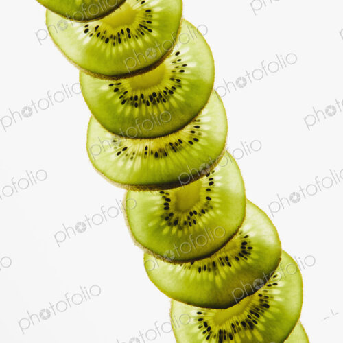 Organic kiwi slices, white background