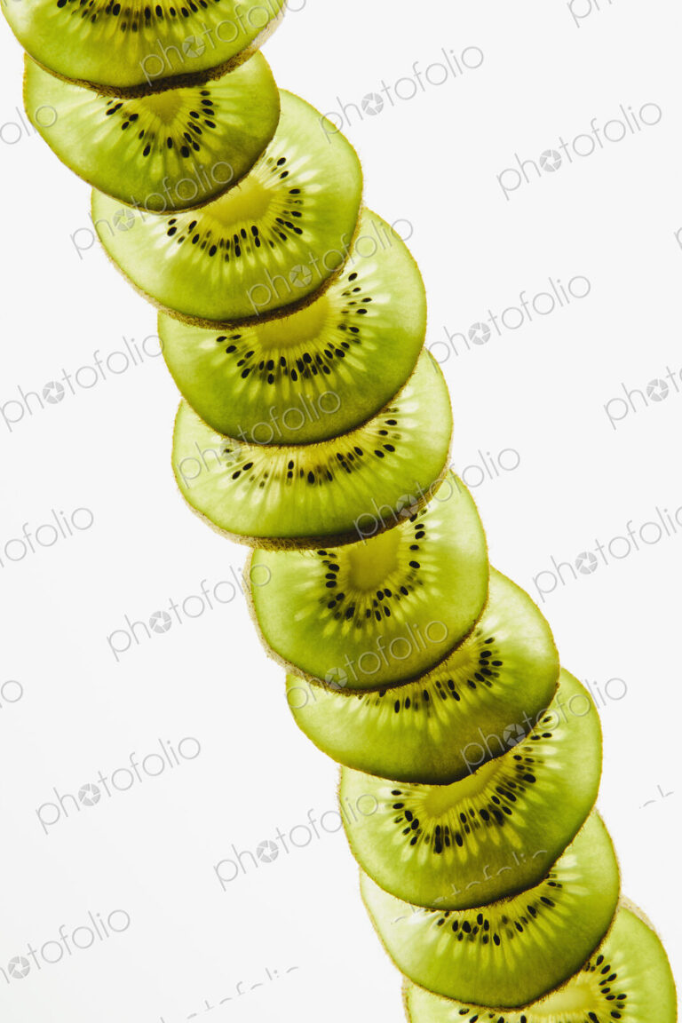 Organic kiwi slices, white background