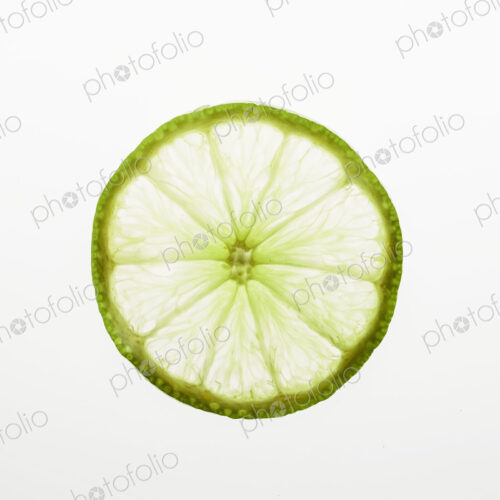 Organic lime slice on white background