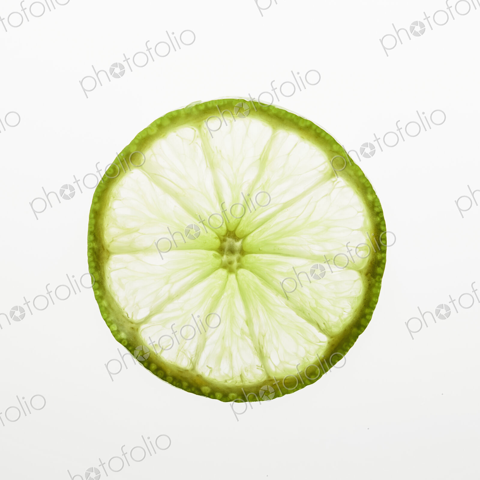 Organic lime slice on white background