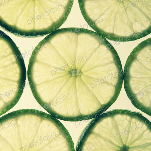 Organic lime slices on white background