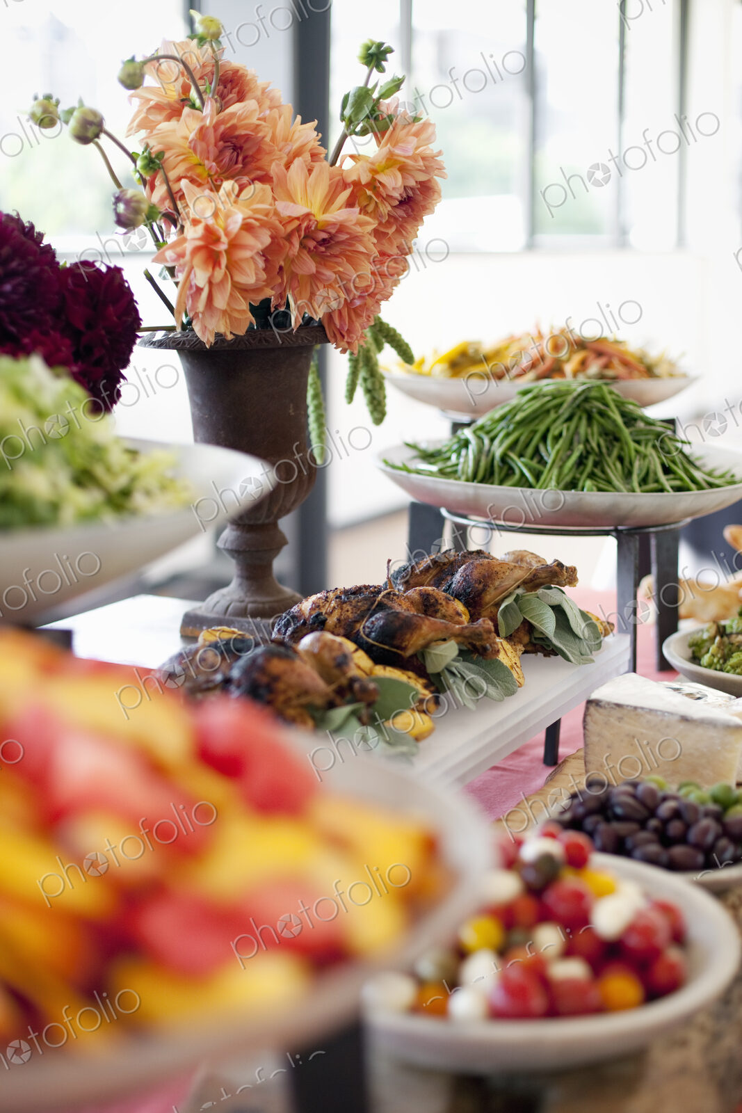 Organic prepared salads, vegetables and fruit on dishes, laid out for a party. A laden…