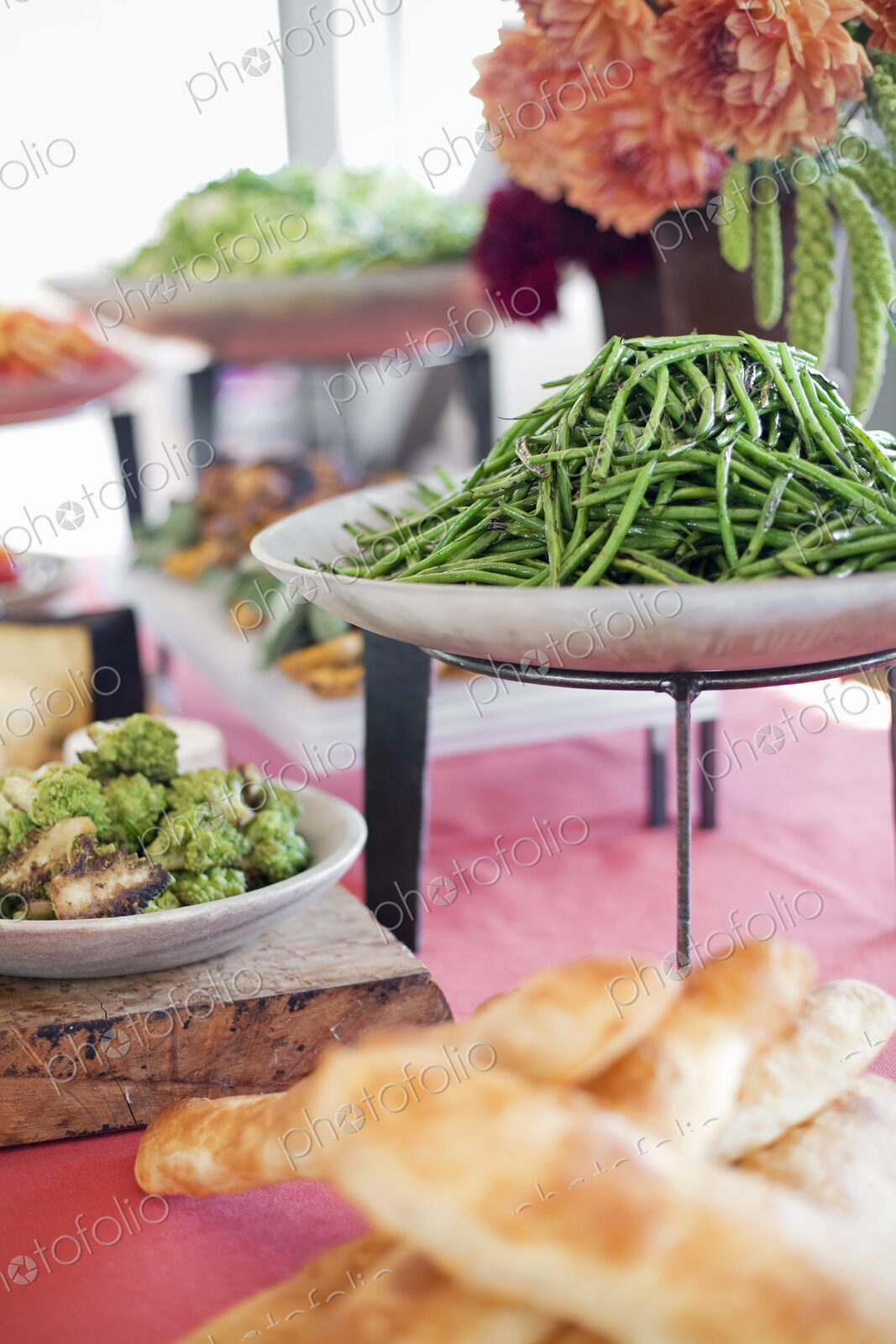 Organic prepared salads, vegetables and fruit on dishes, laid out for a party. A laden…