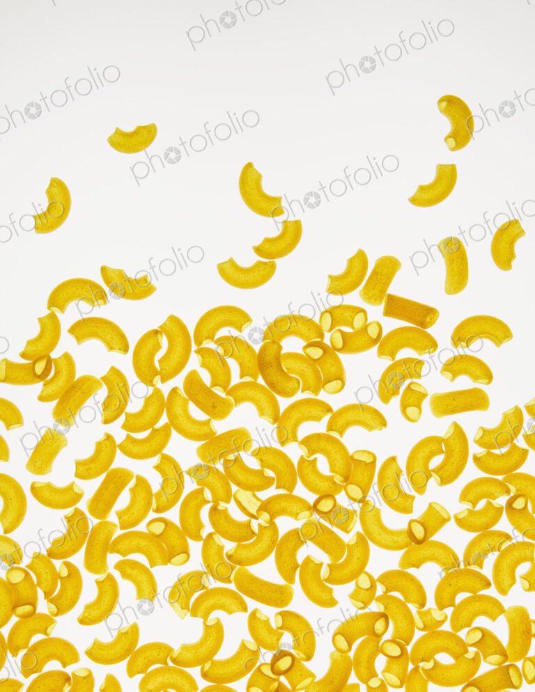 Organic quinoa macaroni pasta elbows, white background (pasta is gluten free)