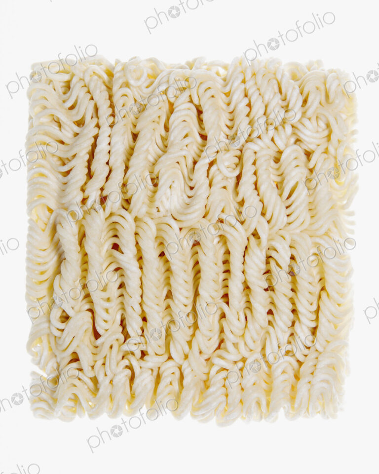 Organic wheat flour ramen noodles, a portion of dried noodles on a white background.