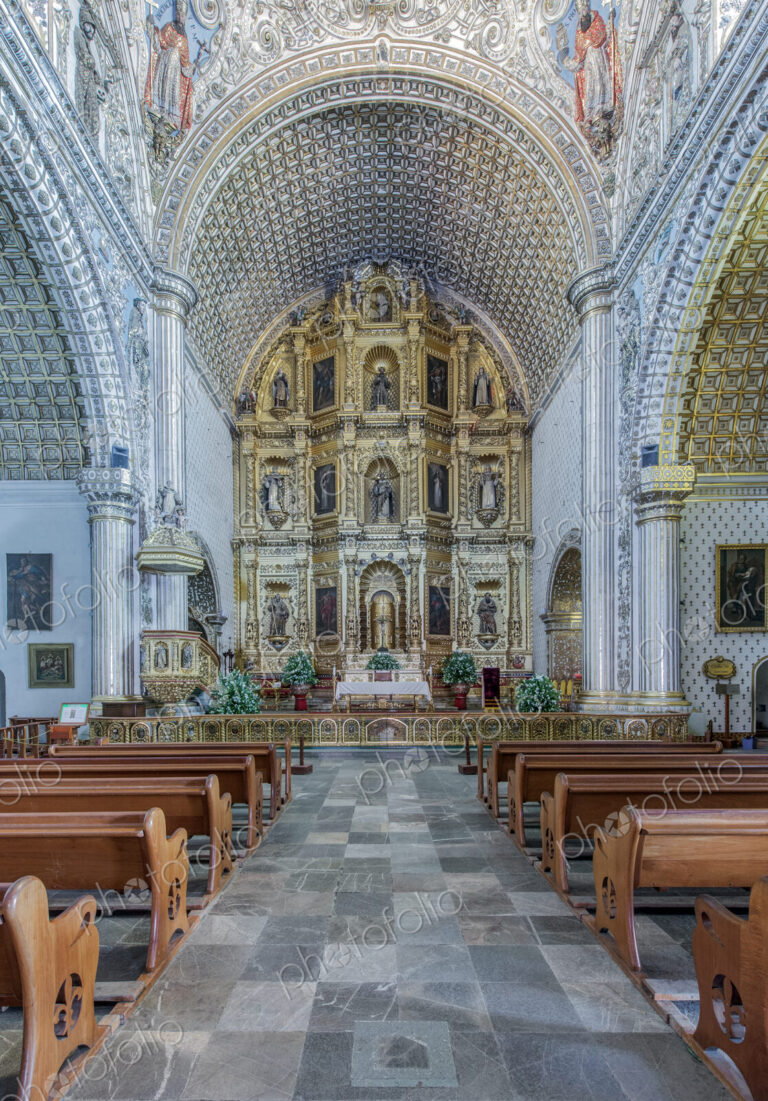 Ornate altar and pews in church