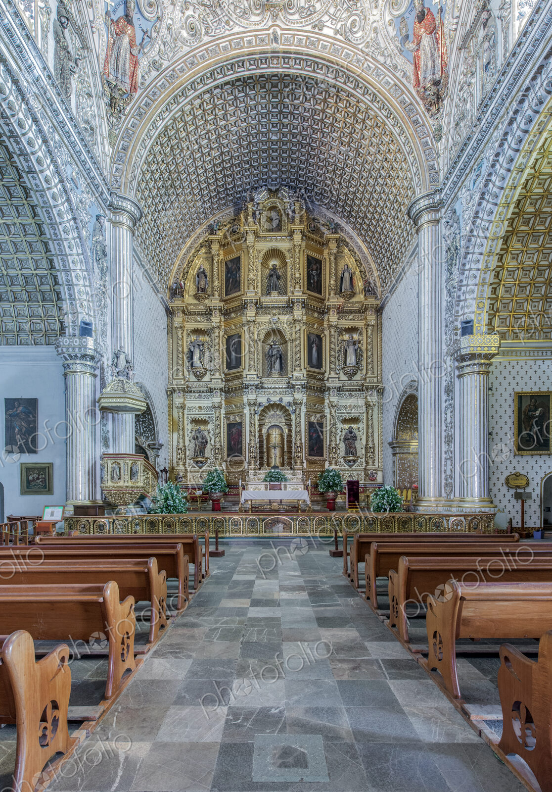 Ornate altar and pews in church