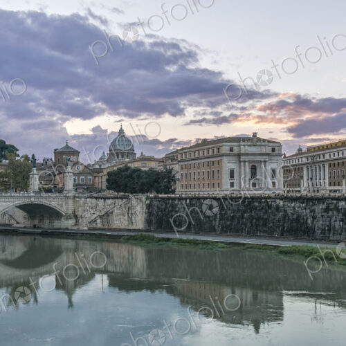 Ornate buildings and bridge reflecting in still river, Rome, Italy Ornate buildings and bridge reflecting in still river, Rome, Italy